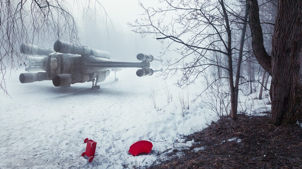 An X-wing starfighter parked on a snowy field in foggy weather. Some red cildren's toys visible on the foreground suggesting a location on Earth.